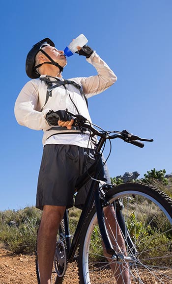 Cyclist drinking water to avoid oral health issues