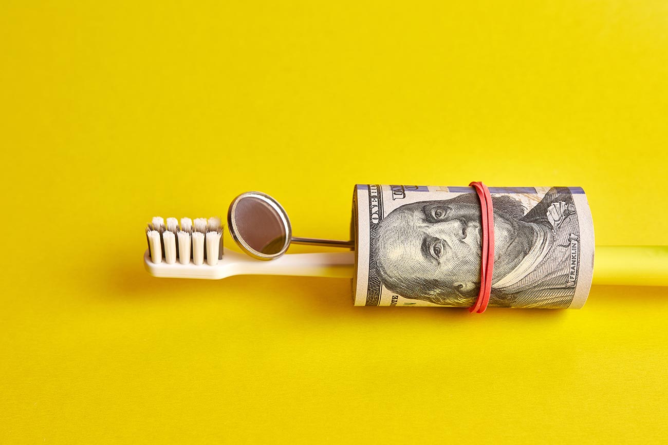 "I Don't Think I Need All This Dentistry." Tooth brush, dental mirror and money showing expense